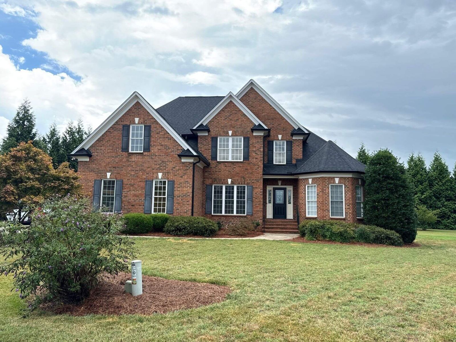 Two-story brick home with a new Charcoal shingle roof