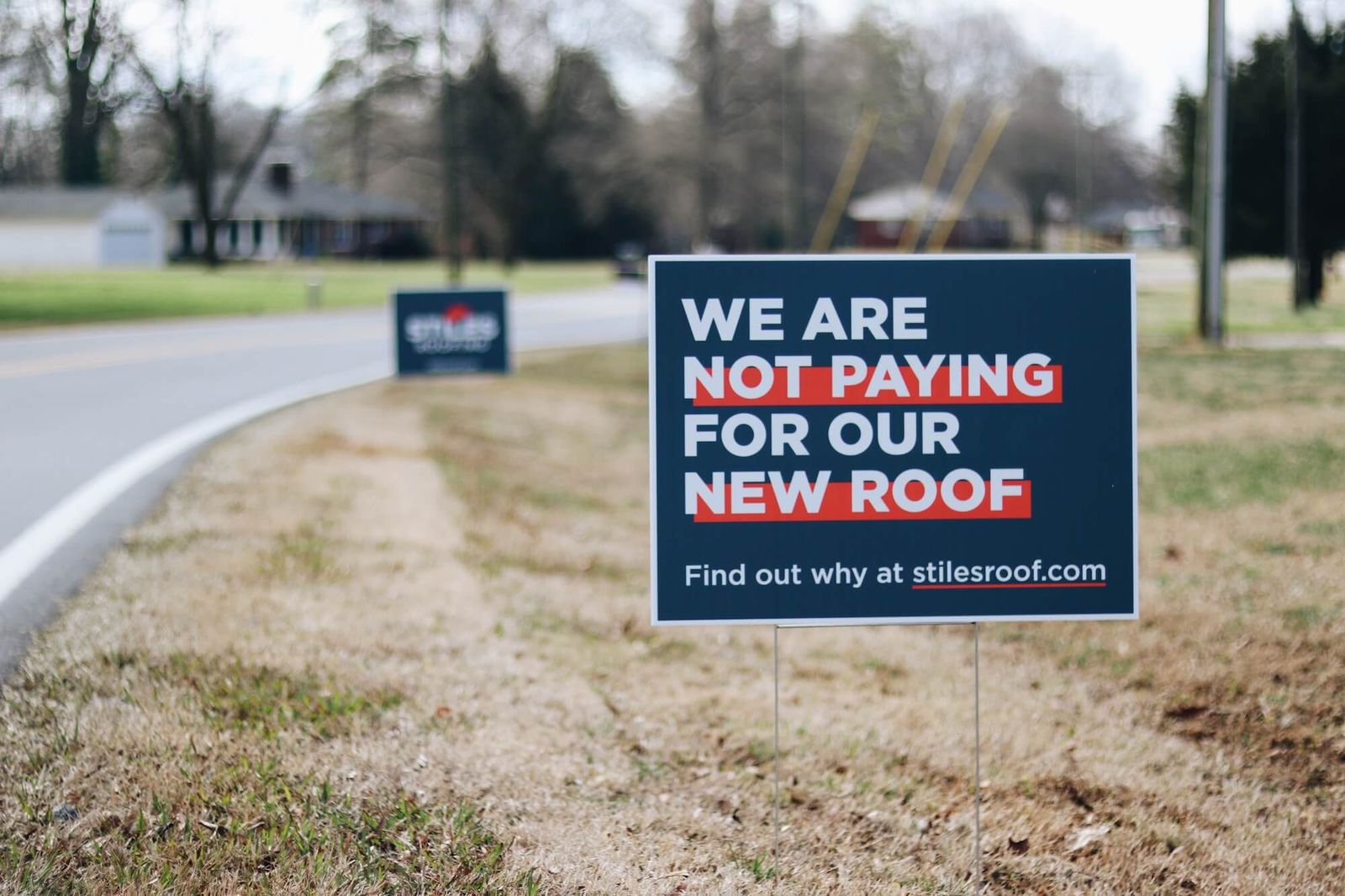 Stiles Roofing storm damage yard sign in front of a home